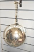 A silver mercury circular glass pendent with handing chain, w24cm