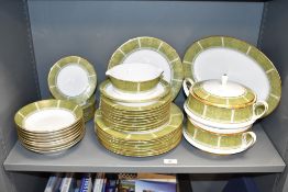 A Noritake Eroica pattern dinner service, decorated with gold and green colour edging on an ice