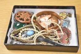 An assortment of costume jewellery, including faux pearls, enamel pieces, brooches, and paste set