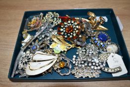 A collection of brooches, including paste set pieces, statement pieces and a cameo