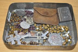 A collection of Rosary beads and Christian related badges and pendants