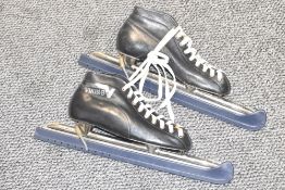 A pair of vintage Viking ice skates, in black leather with plastic blade caps still attached, size