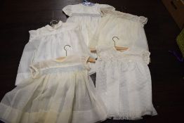 Five newborn baby garments, comprising five hand knitted garments in cream crochet: a bonnet with