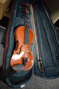 A Stentor Music Co Ltd violin with bow in carry case. The varnish is peeling to the back of the