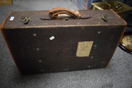 An early 20th century canvas suitcase, having solid brass fittings, leather handle and original