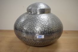A contemporary hand beaten white metal Indian vase in globular form, factory sticker to base '