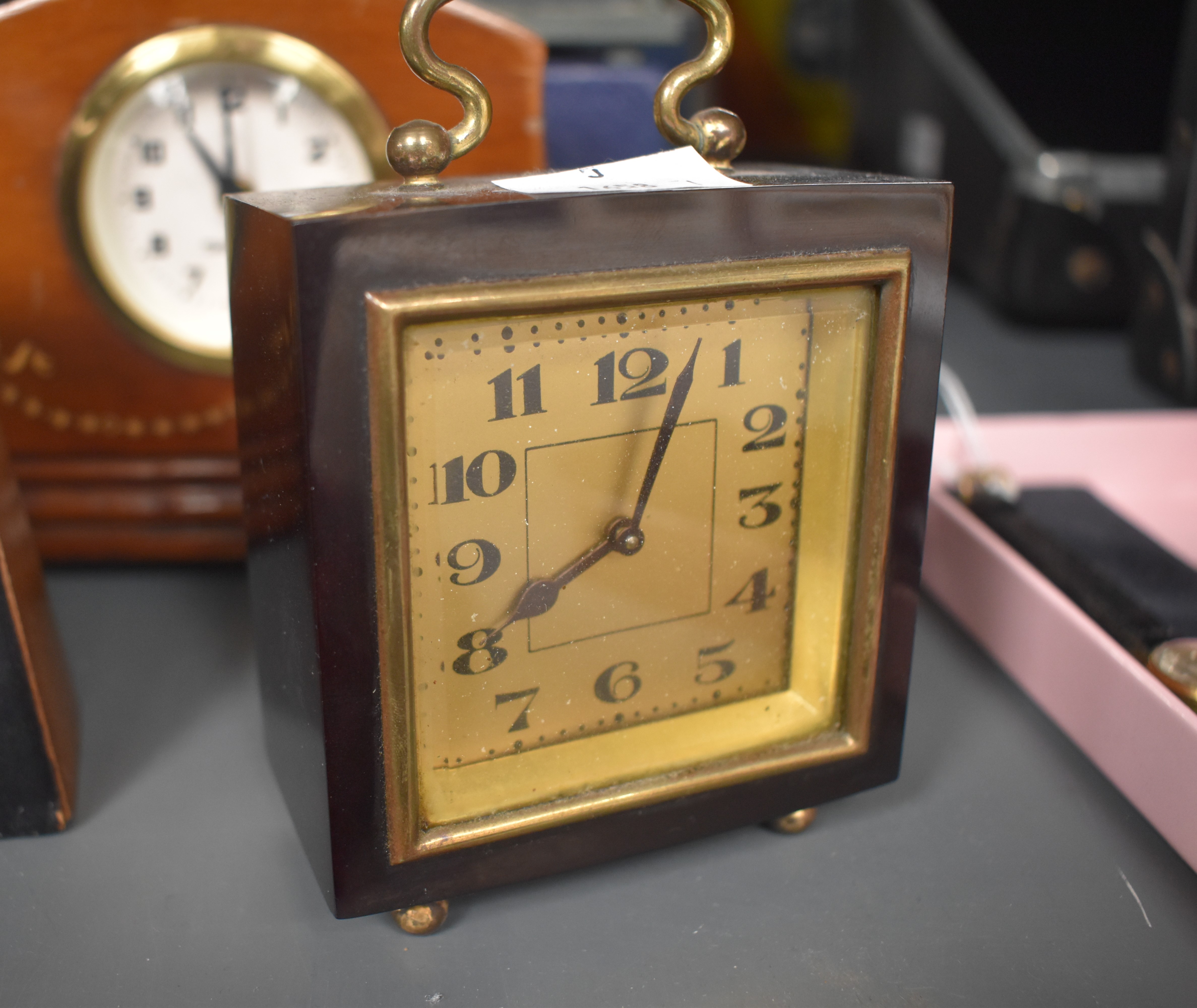 An early 20th century deep red bakelite miniature travel clock, H10cm, sold together with various - Image 4 of 5