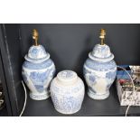 A pair of blue and white ceramic table lamps, decorated with fruit and foliage, h34cm, sold together