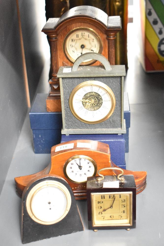 An early 20th century deep red bakelite miniature travel clock, H10cm, sold together with various