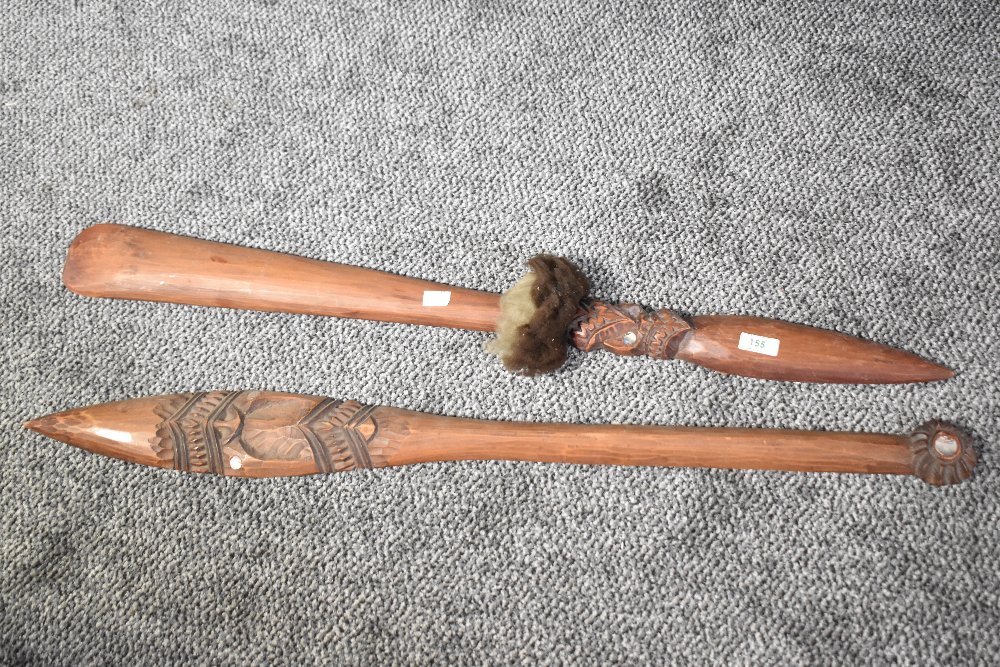 A tribal hand club style Taiaha, carved with inlaid mother of pearl paua eyes, L91cm
