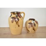 An early 20th century Bristol pottery pitcher, hand coloured with floral patterns, impressed mark to