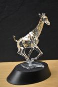 A Swarovski Crystal Giraffe study in amber, complete with box and display stand.