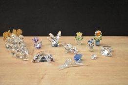 An assortment of Swarovski Crystal flowers also including a large bunch of grapes and a baby bird