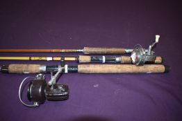 Three vintage fishing rods two fibreglass and one split cane two of which have vintage spinning
