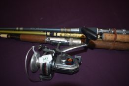Four fibreglass spinnning rods one with a Daiwa A-400RL reel attached