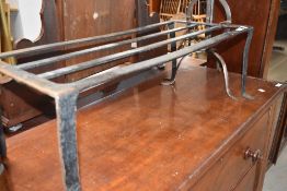 A traditional cast iron footman and a similar fireside bird roaster