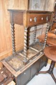 An early 20th Century oak hall table having frieze drawer amd barey twist legs, and a mid 20th