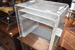 A vintage Perspex nest of three tables, in the ghost style, width 41cm