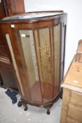 A 1950s walnut corner display cabinet