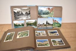 Two vintage photograph albums containing a collection of photographs from travels around the world