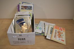 A box containing various post cards and stamp albums, to in include Dorset, Salmon, College of
