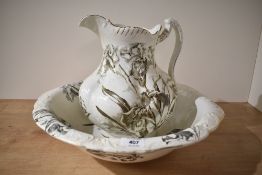 A Victorian water jug and bowl having monochrome transfer print of Irises and flags with the leaf