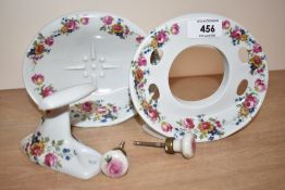 Three porcelain Italian bathroom wall mounts decorated with floral patterns.