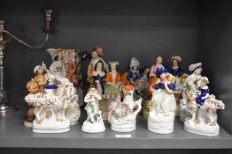 A collection of thirteen Staffordshire Pottery figures and figure groups, various to include bird
