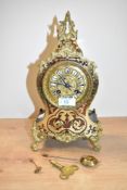 A late 19th 8-day mantel Boulle clock with key, decorated having ebonised case with brass and red