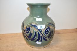 A Langrigg studio pottery vase, having a flared rim over a short neck and globular body decorated