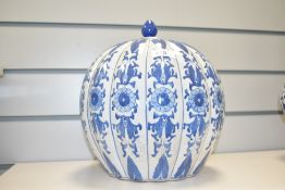A 20th century blue and white lidded ginger jar having ribbed body and floral patterns, h26cm