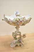 A German Sitzendorf porcelain centrepiece, decorated with foliage and cherubs, painted mark to base,