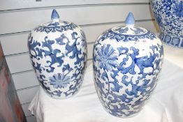 A pair of blue and white lidded ginger jars decorated with floral patterns , h35cm