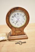 A T.W.Long & Co, Cardiff balloon shaped mantel clock, having enamel dial, boxwood shell decoration
