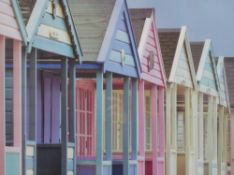 A decorative colour photographic print, colourful beach huts, within a white card mount and white