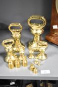 A set of 13 brass weights, some having impressed marks to base, largest h17.5cm