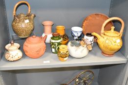 A studio pottery tea pot having bamboo handle and geometrical patterns on a yellow glaze ground,