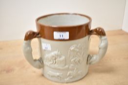 A salt glazed stoneware loving cup decorated with hunting greyhound scenes, 16.5cm