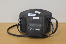 A Canon AV-1 35mm film camera, with Canon branded leather case and strap.