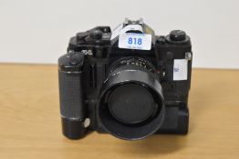 A Canon A-1 with Canon FD 50mm f1.4 lens, BS-52 lens hood and vertical battery grip.
