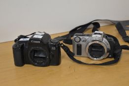 Two Canon film cameras, a Canon EOS 1000f 35mm camera and a Canon EOS IX Advanced Photo System