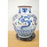 A 19th-century chinese porcelain vase, of lobed balaster form, decorated with dragons, waves and