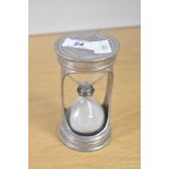 A 20th-century Marinoni pewter Hourglass, having a decorative floral engraving, impressed with