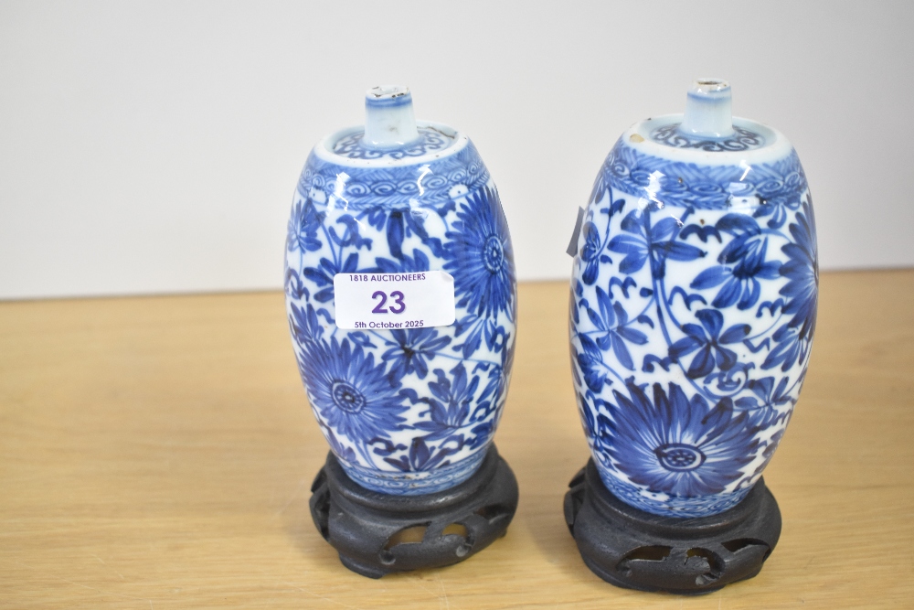 A pair of Chinese porcelain 'spirit' bottles, each of cylindrical form with a tapered, rounded