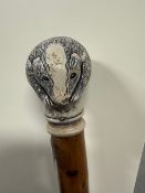 A walking stick with a metal ferrule to base and a resin top in the form of a badger cub measuring