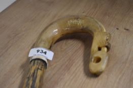 A wooden ash shafted walking stick with crook top and a thistle carving to the crook tip measuring