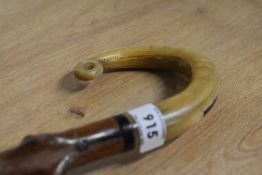 A blackthorn walking cane with carved shepherds crook handle measuring 84cm long