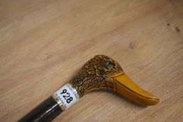 A wooden shafted walking stick with carved wooden duck head handle measuring 93cm long
