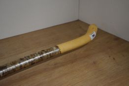 A crooked silver birch walking stick with a shaved handle and rubber foot measuring 135cm long
