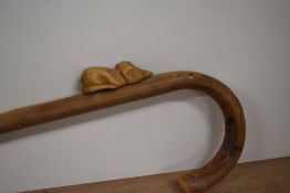 A cane walking stick with brass ferrule to base and a wooden carved mouse attached to the shaft